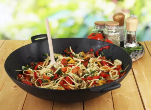 Stir-frying noodles for Chow Mein in a wok.