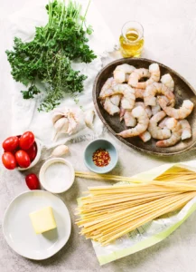 Ingredients for Shrimp Lo Mein recipe, including shrimp, noodles, and vegetables.