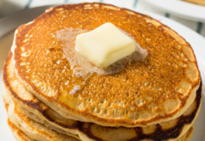 Fluffy pancakes being grilled at Cracker Barrel using canola oil.