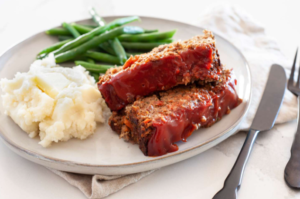 Traditional meatloaf served with classic side dishes.